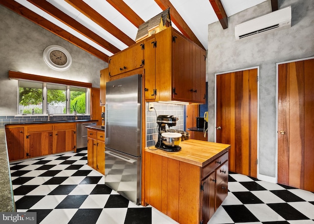 320 S Main St, Quakertown, PA 18951 - kitchen featuring appliances with stainless steel finishes, light floors, a wall mounted air conditioner, beam ceiling, and high vaulted ceiling