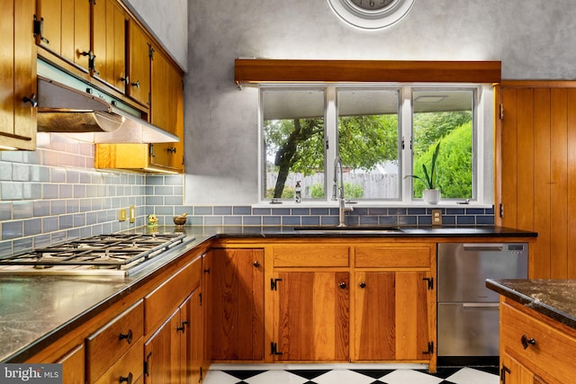 320 S Main St, Quakertown, PA 18951 - kitchen featuring appliances with stainless steel finishes, under cabinet range hood, tile patterned floors, and brown cabinets