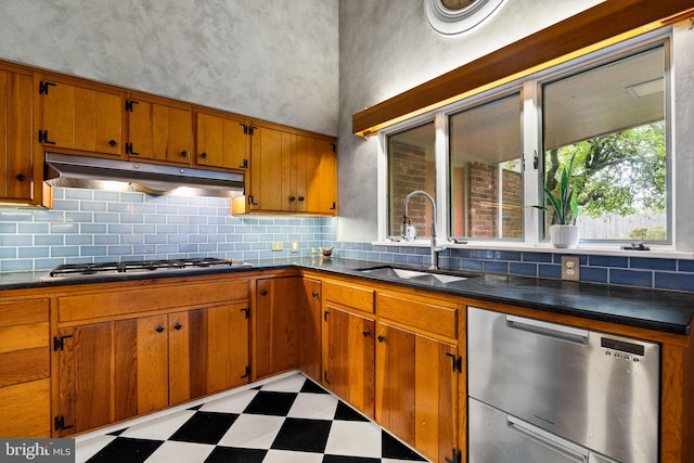320 S Main St, Quakertown, PA 18951 - kitchen featuring stainless steel appliances, light floors, under cabinet range hood, and decorative backsplash