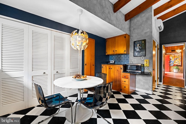 320 S Main St, Quakertown, PA 18951 - kitchen with light floors, stainless steel microwave, a wall mounted AC, a towering ceiling, and dark countertops