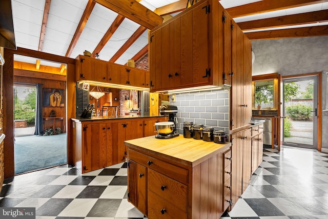 320 S Main St, Quakertown, PA 18951 - kitchen with dark flooring, butcher block counters, brown cabinets, and tasteful backsplash