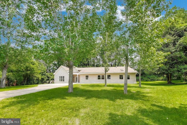 3603 John Ct, Annandale, VA 22003 - view of front facade with a front lawn, driveway, and view of wooded area