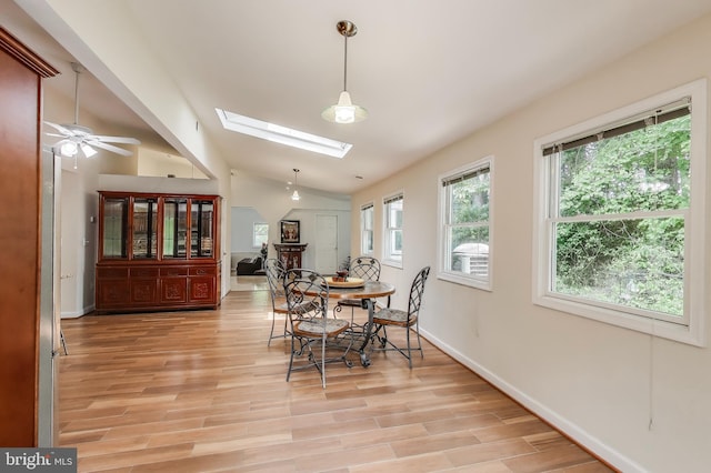 3603 John Ct, Annandale, VA 22003 - dining area featuring a skylight, lofted ceiling, light wood-type flooring, ceiling fan, and baseboards