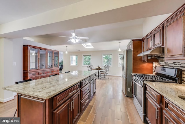 3603 John Ct, Annandale, VA 22003 - kitchen featuring appliances with stainless steel finishes, under cabinet range hood, ceiling fan, baseboards, and light wood finished floors