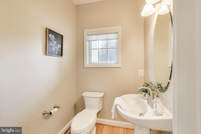 2177 S Glebe Rd, Arlington, VA 22204 - half bath with toilet, baseboards, wood finished floors, and a sink