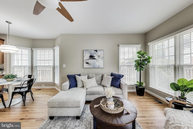 2177 S Glebe Rd, Arlington, VA 22204 - living area with light wood-style floors, baseboards, and a ceiling fan