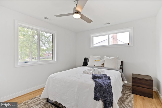 418 Belton Ct, Silver Spring, MD 20901 - bedroom featuring multiple windows, light wood-type flooring, and baseboards
