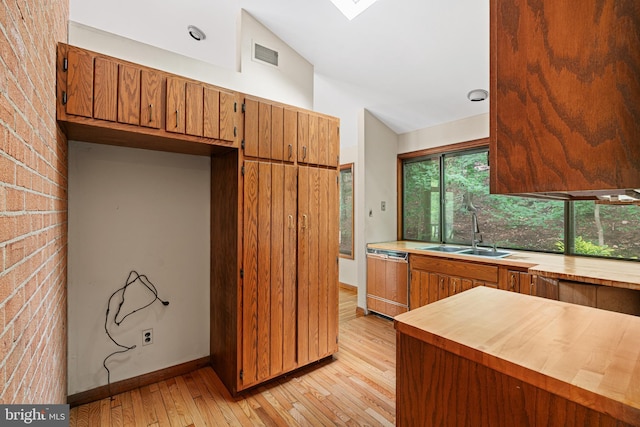 475 Arden, Gulph Mills, PA 19428 - kitchen with dishwashing machine, butcher block counters, vaulted ceiling, light wood-style floors, and brown cabinets