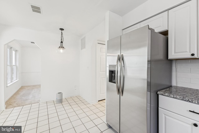 6248 Light Point Pl, Columbia, MD 21045 - kitchen with stainless steel refrigerator with ice dispenser, arched walkways, white cabinetry, pendant lighting, and light tile patterned flooring