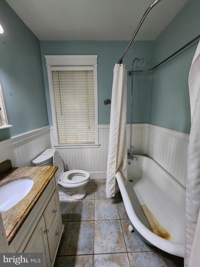 10 Nancy Rd, Wilmington, DE 19809 - full bathroom with wainscoting, toilet, vanity, shower / tub combo, and tile patterned flooring