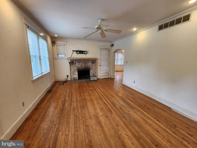 10 Nancy Rd, Wilmington, DE 19809 - unfurnished living room with ceiling fan, ornamental molding, arched walkways, wood finished floors, and a fireplace