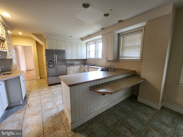 10 Nancy Rd, Wilmington, DE 19809 - kitchen with stainless steel fridge, a sink, a peninsula, white range with gas cooktop, and recessed lighting