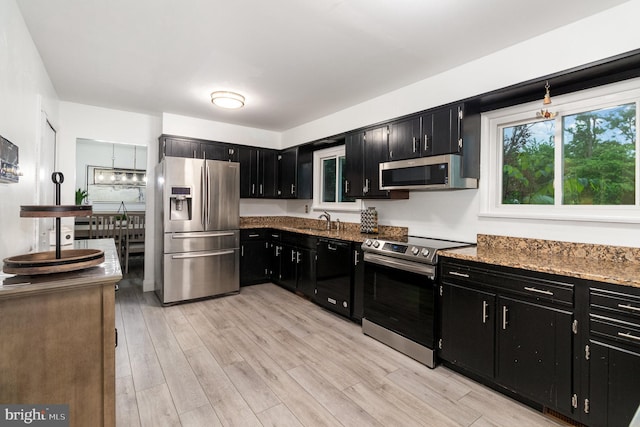 44 Creek Rd, Newville, PA 17241 - kitchen with appliances with stainless steel finishes, dark cabinets, light wood-style flooring, and stone countertops