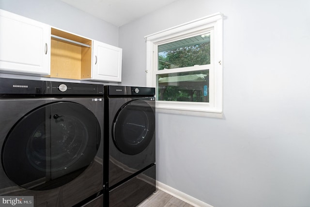 44 Creek Rd, Newville, PA 17241 - laundry area with washer and clothes dryer, wood finished floors, cabinet space, and baseboards