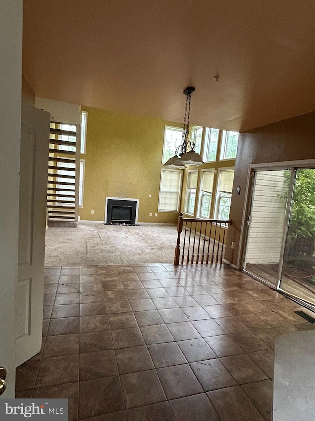 8207 Rison Dr, Brandywine, MD 20613 - unfurnished dining area with dark carpet, baseboards, a fireplace, and dark tile patterned flooring