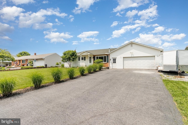 1503 Shirley Ave, Carlisle, PA 17013 - ranch-style house with an attached garage, asphalt driveway, and a front lawn