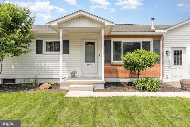 1503 Shirley Ave, Carlisle, PA 17013 - view of front of home featuring brick siding, a front lawn, and roof with shingles