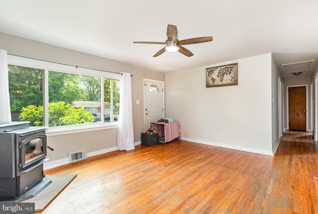 1503 Shirley Ave, Carlisle, PA 17013 - living room featuring a wood stove, hardwood / wood-style flooring, baseboards, and a ceiling fan