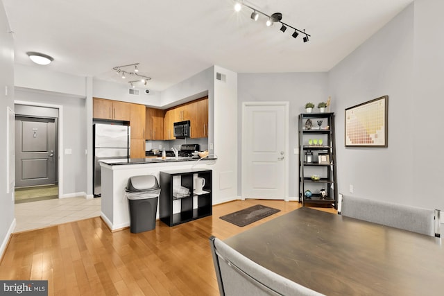 1021 N Garfield St Unit B37, Arlington, VA 22201 - kitchen with black microwave, freestanding refrigerator, rail lighting, and range