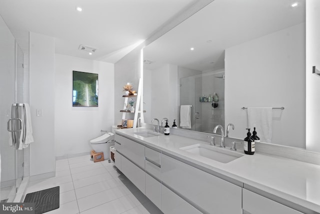 810 O St NW Unit 504, Washington, DC 20001 - bathroom with double vanity, tile patterned flooring, a shower stall, toilet, and recessed lighting