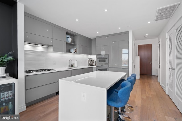 810 O St NW Unit 504, Washington, DC 20001 - kitchen with gray cabinetry, modern cabinets, a kitchen bar, and recessed lighting