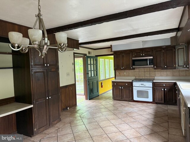 790 Hopewell Rd, Downingtown, PA 19335 - kitchen featuring stainless steel microwave, beam ceiling, a chandelier, dark brown cabinets, and light countertops