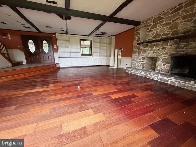 790 Hopewell Rd, Downingtown, PA 19335 - unfurnished living room with wood finished floors, beamed ceiling, a stone fireplace, wainscoting, and stairway
