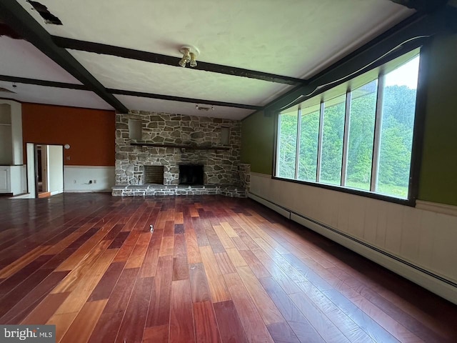 790 Hopewell Rd, Downingtown, PA 19335 - unfurnished living room with a baseboard radiator, beamed ceiling, wainscoting, hardwood / wood-style floors, and a stone fireplace