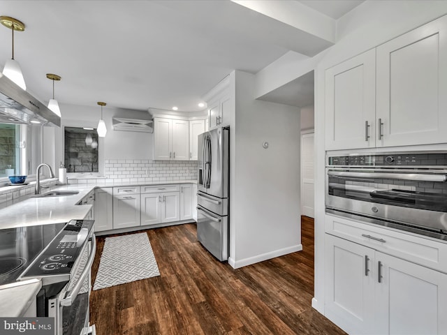 927 Thompson Ave, Jonestown, PA 17038 - kitchen featuring stainless steel appliances, tasteful backsplash, dark wood finished floors, white cabinets, and decorative light fixtures