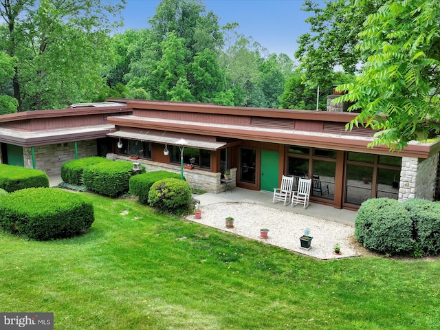 927 Thompson Ave, Jonestown, PA 17038 - back of property featuring a lawn, stone siding, and a patio
