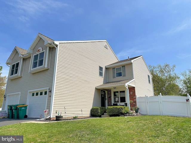 584 Meadow Ln, Pennsburg, PA 18073 - view of front of house with an attached garage, driveway, brick siding, and covered porch