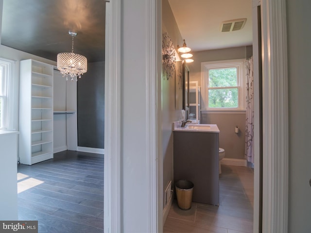 2509 Mason St, Silver Spring, MD 20902 - full bath featuring a chandelier, wood finished floors, vanity, and toilet
