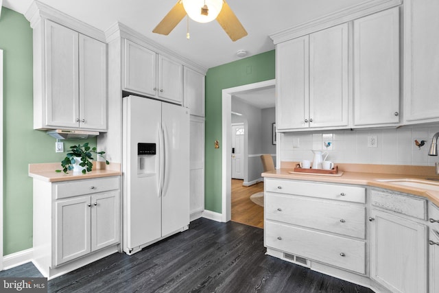 6317 Taylor Rd, Riverdale, MD 20737 - kitchen with white fridge with ice dispenser, light countertops, dark wood finished floors, white cabinetry, and ceiling fan