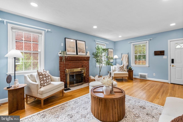 6317 Taylor Rd, Riverdale, MD 20737 - living area featuring wood finished floors, a brick fireplace, and recessed lighting