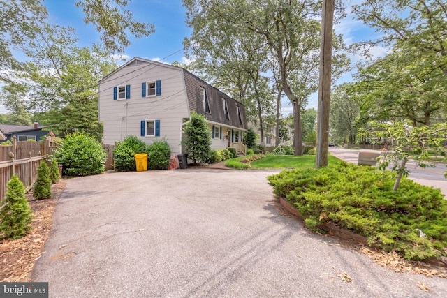 525 Center Dr, Severna Park, MD 21146 - view of property exterior featuring a gambrel roof, asphalt driveway, and a shingled roof
