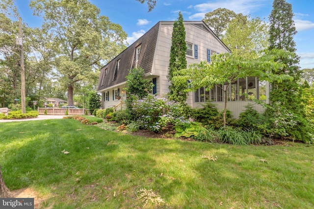 525 Center Dr, Severna Park, MD 21146 - view of home's exterior featuring a lawn, a wooden deck, and a shingled roof