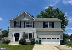 5920 Plata St, Clinton, MD 20735 - view of front of house featuring concrete driveway, an attached garage, and a front lawn