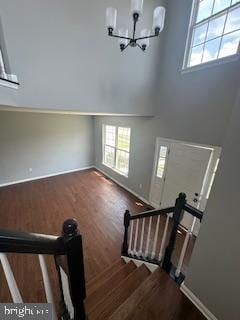 5920 Plata St, Clinton, MD 20735 - staircase with a chandelier, wood finished floors, and a high ceiling