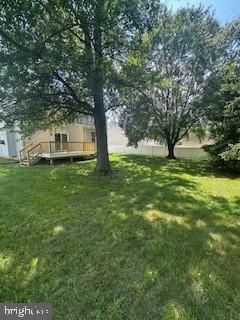 5920 Plata St, Clinton, MD 20735 - view of grassy yard with a wooden deck