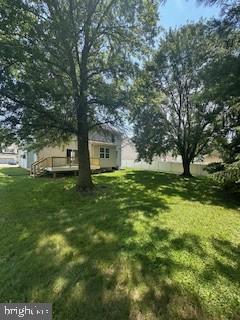 5920 Plata St, Clinton, MD 20735 - view of grassy yard with a wooden deck