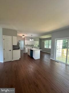 5920 Plata St, Clinton, MD 20735 - unfurnished living room featuring dark wood finished floors and a chandelier
