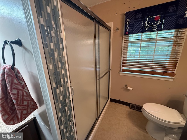 187 Merion Rd, Dover, DE 19904 - bathroom featuring a stall shower, toilet, and tile patterned floors
