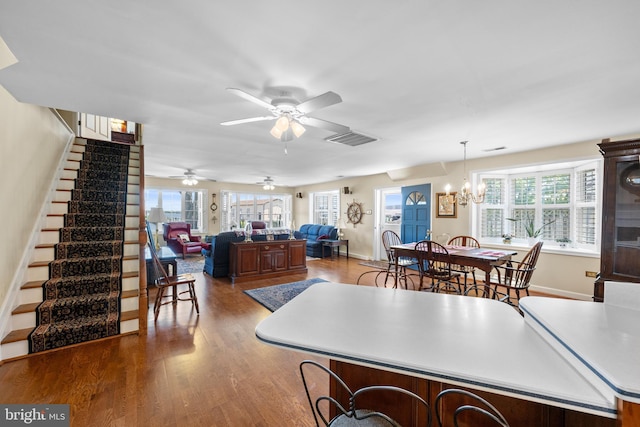 3685 1st Ave, Edgewater, MD 21037 - dining room featuring stairs, wood finished floors, a chandelier, a ceiling fan, and baseboards