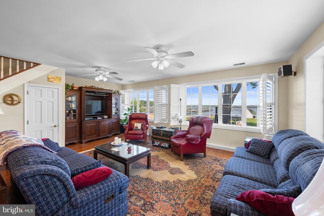 3685 1st Ave, Edgewater, MD 21037 - living area featuring wood finished floors, ceiling fan, and stairs