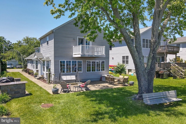 3685 1st Ave, Edgewater, MD 21037 - back of house featuring a balcony, a patio area, and a lawn
