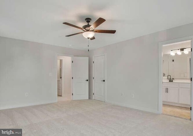 22640 Excel Ct, Lexington Park, MD 20653 - unfurnished bedroom featuring light colored carpet, ensuite bath, baseboards, and a ceiling fan