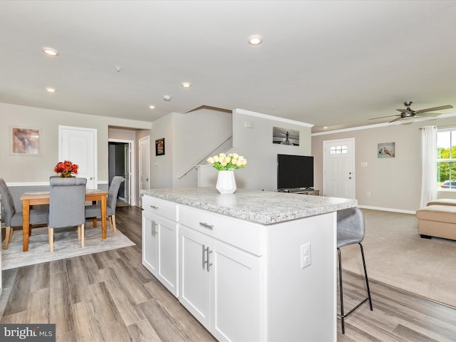 38 Herman Gaver Pl, Hagerstown, MD 21740 - kitchen featuring open floor plan, a kitchen island, a kitchen breakfast bar, white cabinets, and recessed lighting