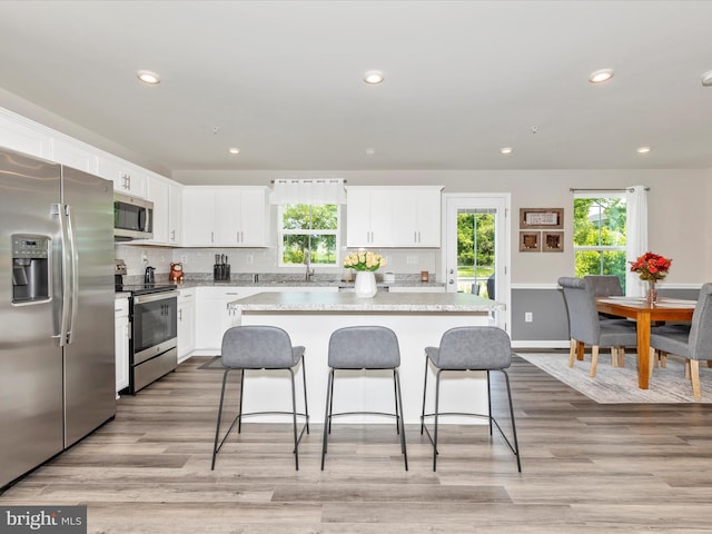 38 Herman Gaver Pl, Hagerstown, MD 21740 - kitchen with stainless steel appliances, healthy amount of natural light, a breakfast bar area, white cabinetry, and recessed lighting