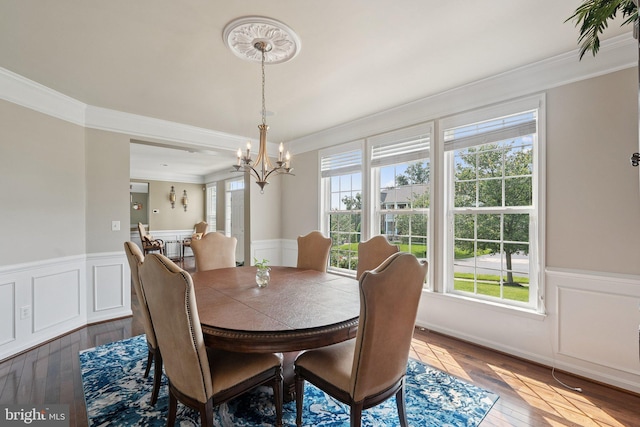21550 Wild Timber Ct, Broadlands, VA 20148 - dining area featuring crown molding, a chandelier, wood-type flooring, and a wainscoted wall