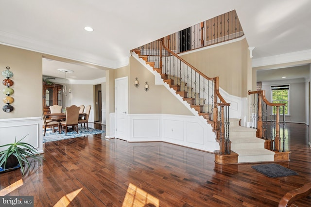 21550 Wild Timber Ct, Broadlands, VA 20148 - foyer entrance with crown molding, hardwood / wood-style floors, stairs, a decorative wall, and wainscoting
